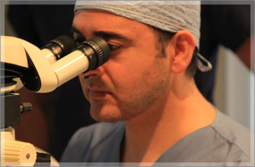 Eye doctor using a microscope